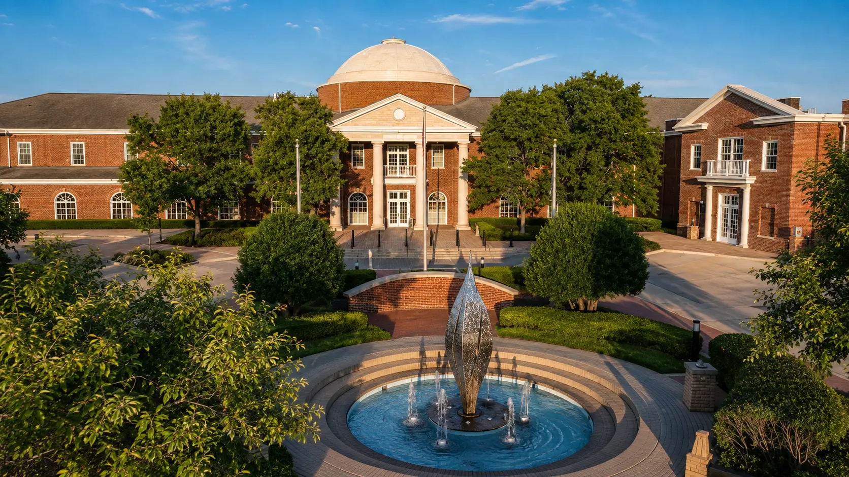 Fountain and domed brick civic building surrounded by landscaped grounds in Addison, Illinois